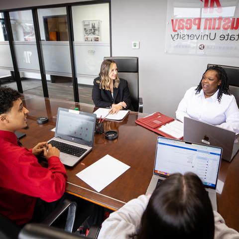 Graduates students sitting in a board room